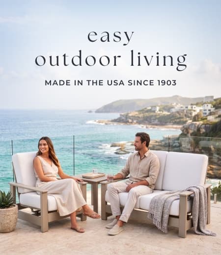 Couple sits on oceanside patio furniture. Image Text: easy outdoor living MADE IN THE USA SINCE 1903