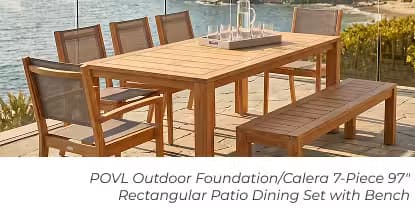 Teak outdoor dining set with six chairs and a bench on a coastal patio.
