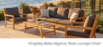 Teak outdoor sofa and lounge chairs with gray cushions surrounding a rectangular coffee table.