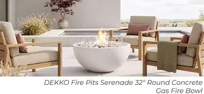 White DEKKO Serenade round gas fire bowl with white fire media surrounded by four lounge chairs.