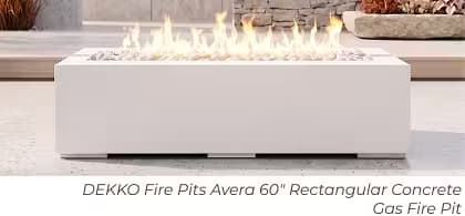 White DEKKO Avera rectangular gas fire pit with flames and white fire media on a modern patio.