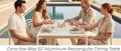 Four friends gathered around a white aluminum outdoor dining table beside a pool.