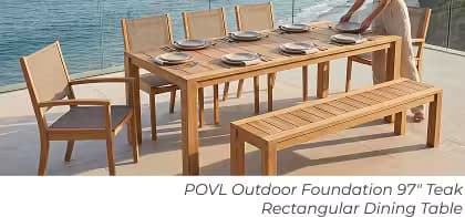 Teak rectangular outdoor dining table with chairs and bench set for a meal beside the ocean.